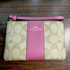 Coach Signature pink and tan wristlet.